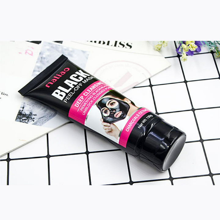 Tube of black peel-off mask on a checkered surface. maliao.pk