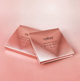 Two rose gold 'maliao' highlight palette boxes on a pink background