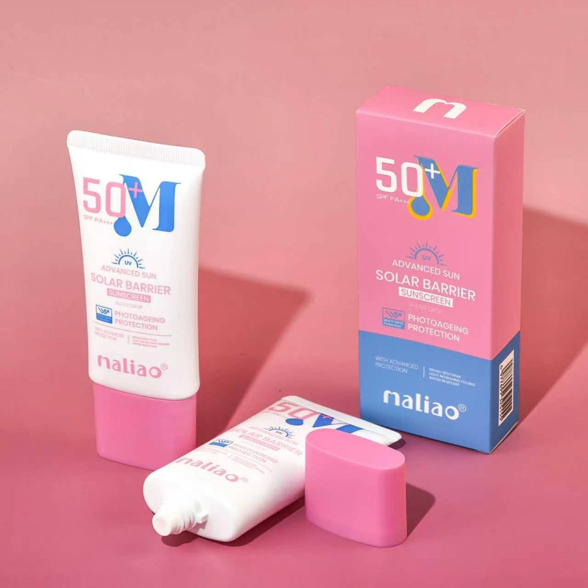 Naliao 50+ UV Solar Barrier Sunscreen shown with a white and pink squeeze tube, its pink and blue retail box, and a detached pink cap on a solid pink background.