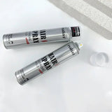 Two cans of hair spray with visible labels on a white surface.