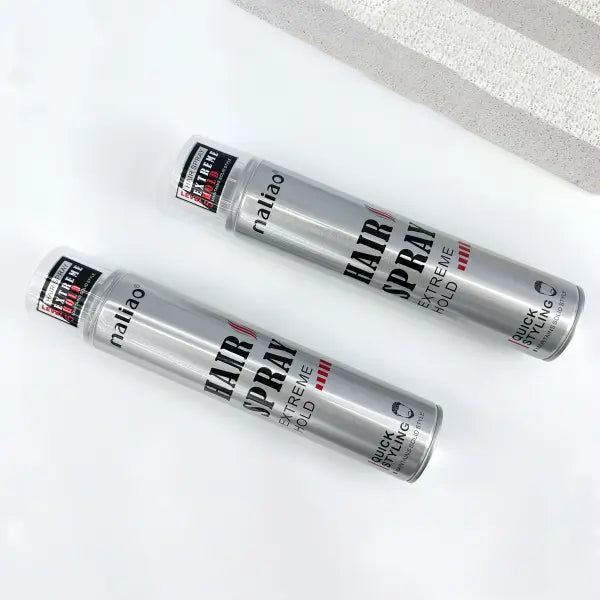 Two bottles of hair spray labeled 'Hair Spray Extreme Hold' on a white background.