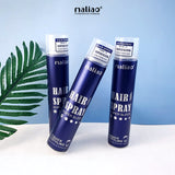 Three bottles of maliao hair spray on a white surface with a blue background