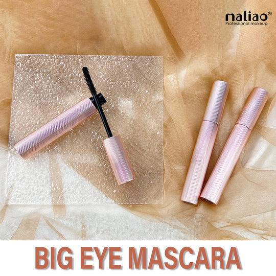 Maliao mascara with open cap on a textured beige background. maliao.pk