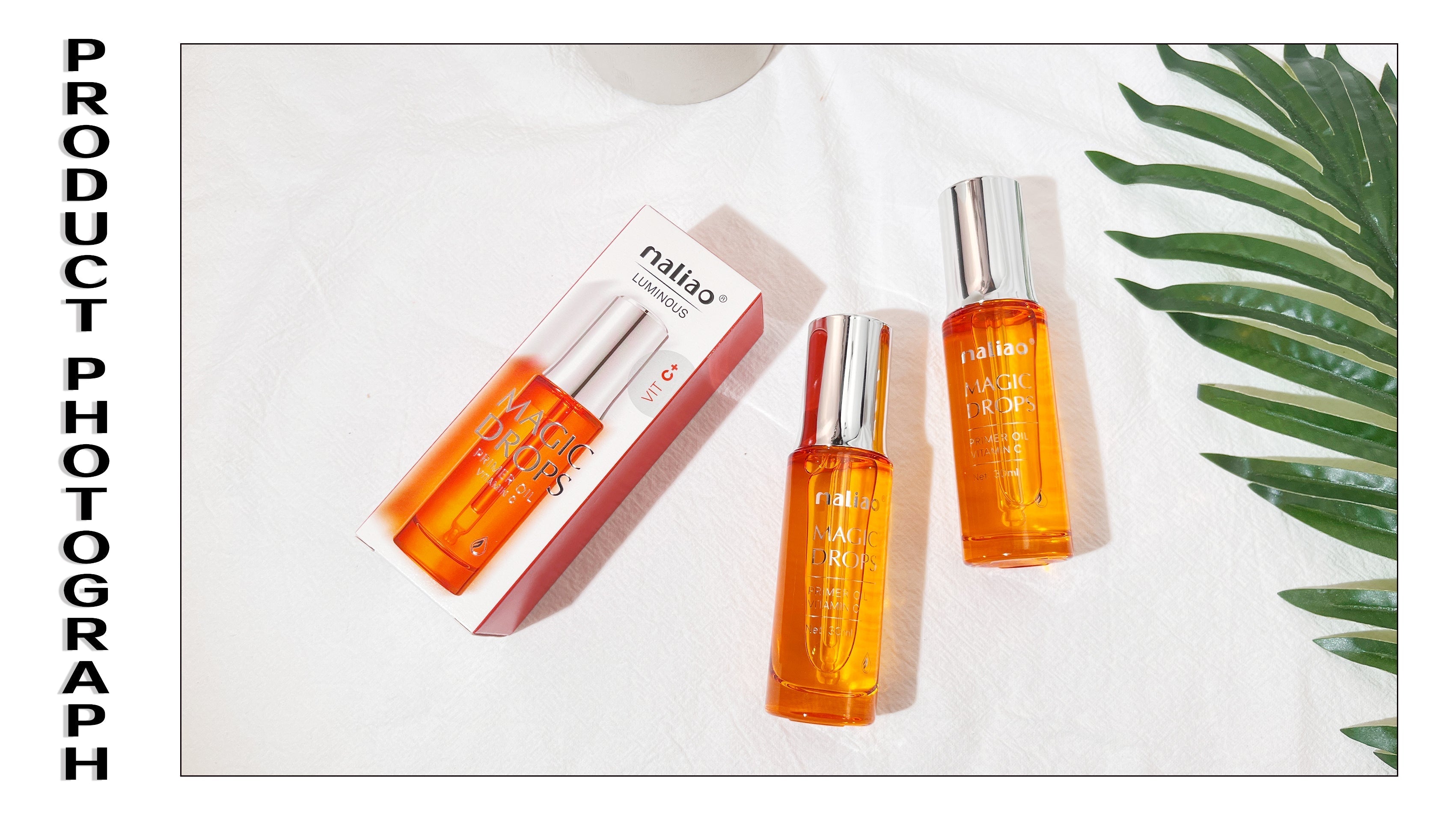 Three orange skincare bottles with silver caps on a white background with a green leaf.