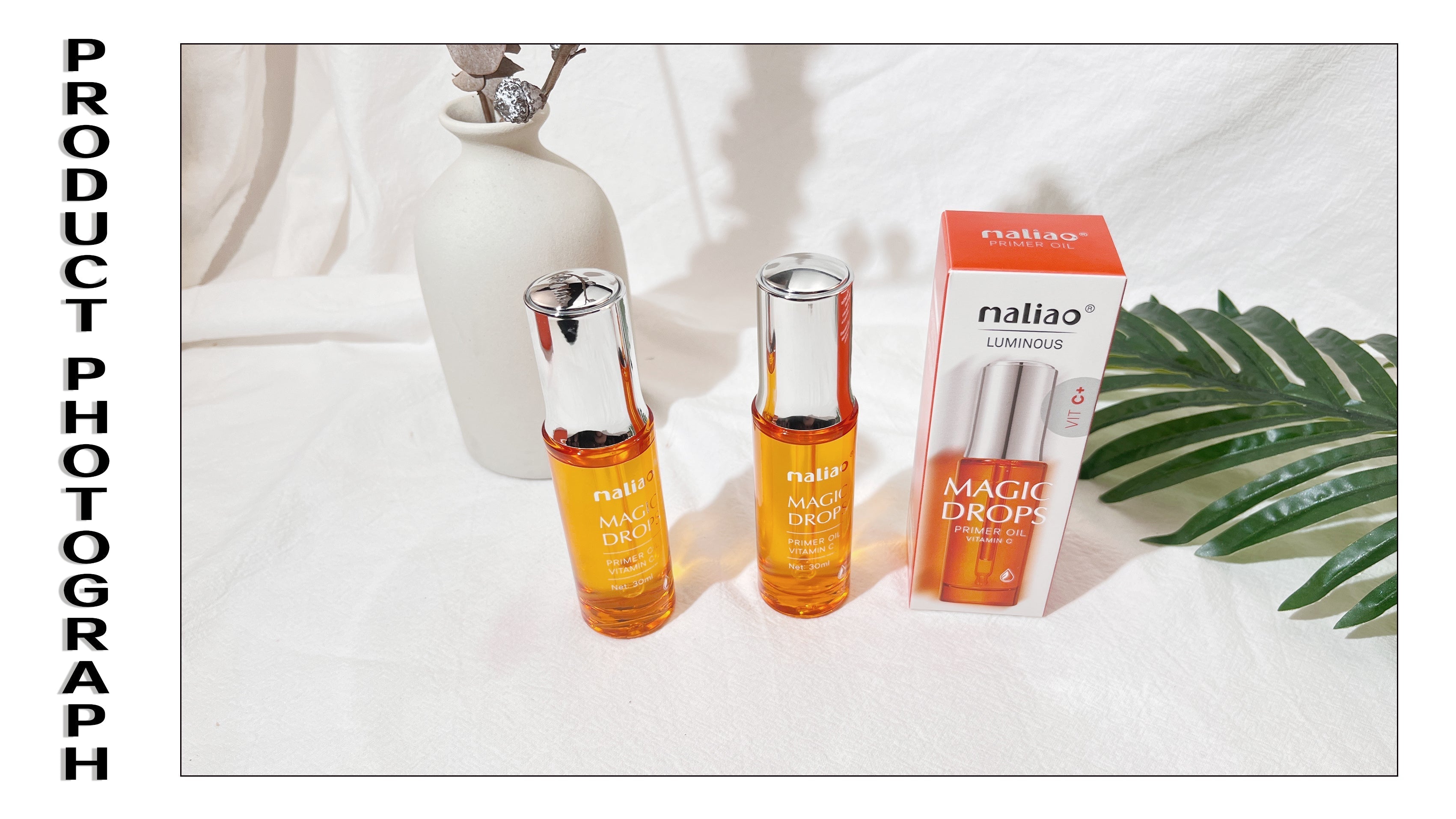 Two bottles and a box of 'maliao' magic drops on a white background with a plant leaf.