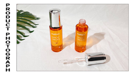 Two bottles of facial oil with a dropper on a white background