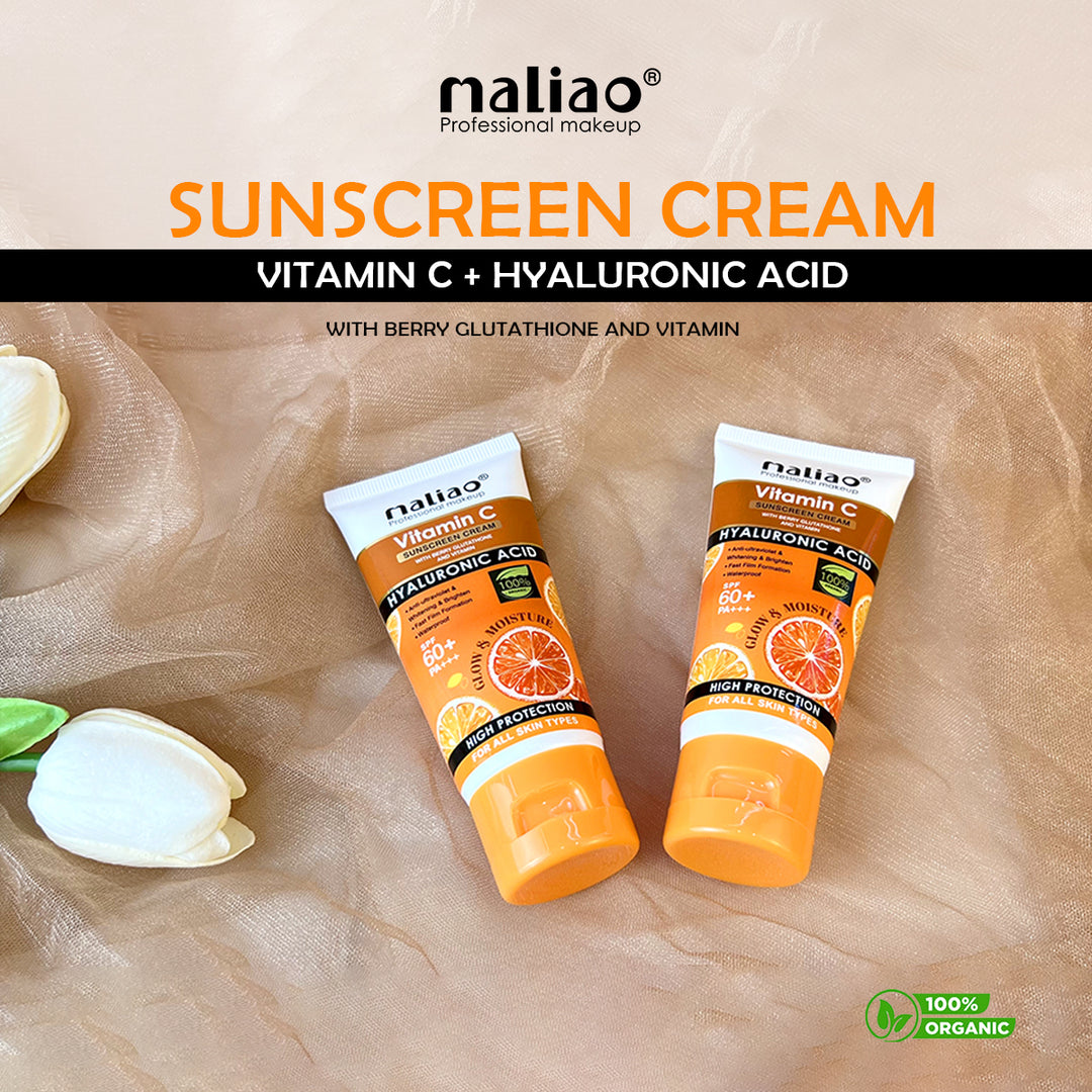 Two tubes of Naliao sunscreen cream with vitamin C and hyaluronic acid on a beige fabric background. maliao.pk